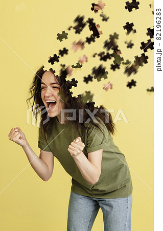 Modern collage of caucasian girl isolated over yellow background. Female head consist of puzzle pieces. 82196283