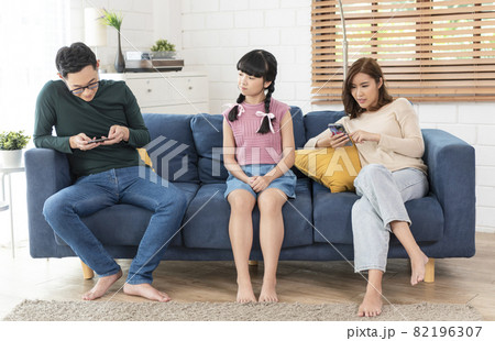 Asian parent using tablet and mobile phones at home. addicted to devices, gadgets dependence overuse. Asian parent using tablet and mobile phones at home. addicted to devices, gadgets dependence overuse. 82196307