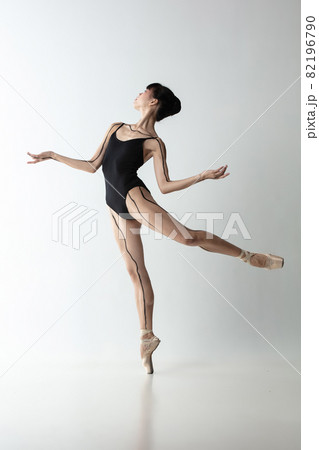 Full-length portrait of graceful ballet dancer, ballerina dancing isolated on light gray studio background. Art, motion, action, flexibility, inspiration concept. Full-length portrait of graceful ballet dancer, ballerina dancing isolated on light gray studio background. Art, motion, action, flexibility, inspiration concept. 82196790