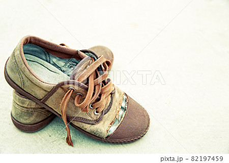 Old shoes on dirty background Old shoes on dirty background 82197459