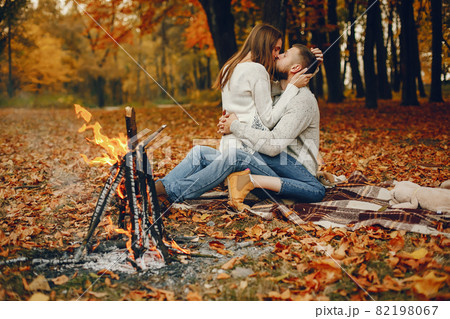 Elegant couple spend time in a autumn park Elegant couple spend time in a autumn park 82198067