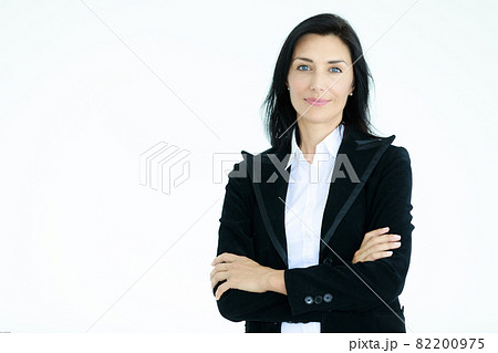 Portrait of beautiful woman in black suit standing in front of white background Portrait of beautiful woman in black suit standing in front of white background 82200975