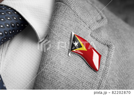 Metal badge with the flag of East Timor on a suit lapel 82202870