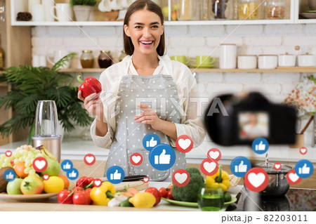 Happy young european lady food blogger or chef, prepare healthy vegetarian meal, look at camera 82203011