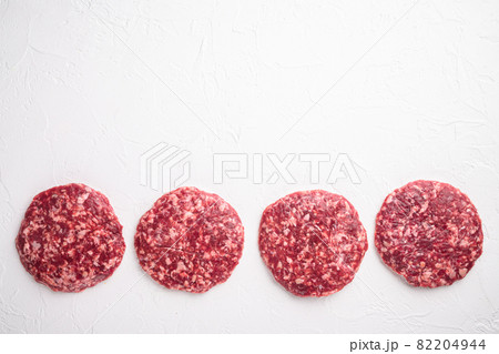 Raw Minced Steak Burgers from Beef Meat, on white stone background, top view flat lay, with copy space for text Raw Minced Steak Burgers from Beef Meat, on white stone background, top view flat lay, with copy space for text 82204944