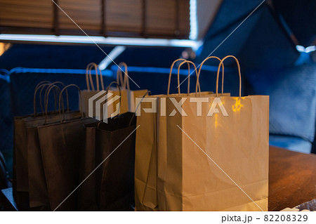 Courier delivery food service at home. Woman courier delivered the order no name bag with food. Courier delivery food service at home. Woman courier delivered the order no name bag with food. 82208329