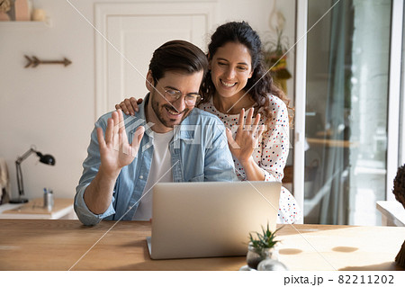 Couple make video call using laptop talking with relatives remotely Couple make video call using laptop talking with relatives remotely 82211202