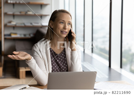 Young Caucasian businesswoman talk with client on smartphone Young Caucasian businesswoman talk with client on smartphone 82211690