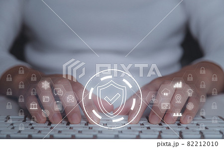 Business woman working on laptop with shield protect icon on virtual screen. Cybersecurity network of connected devices and personal data security of the organization concept. 82212010