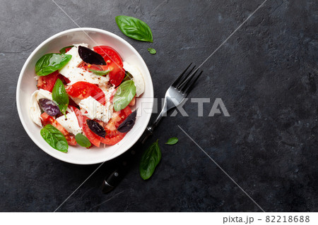 Caprese salad with fresh tomatoes, basil and mozzarella cheese Caprese salad with fresh tomatoes, basil and mozzarella cheese 82218688