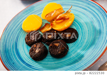 Fried blood sausage with potatoes served at plate 82222530