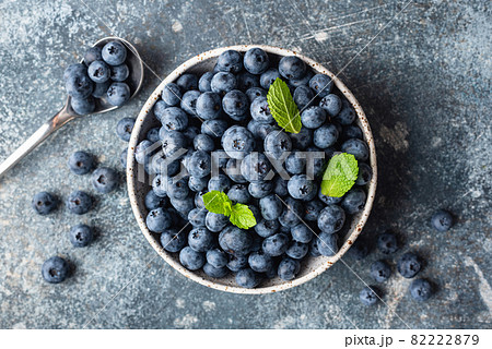 Fresh blueberries in bowl on concrete background 82222879