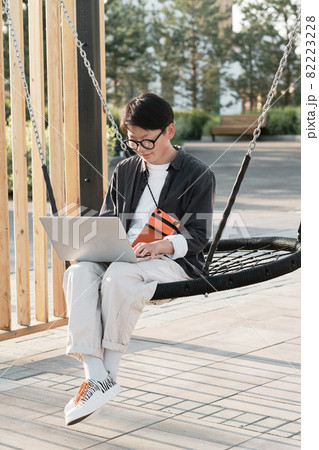 Asian Freelancer Working Outdoors Asian Freelancer Working Outdoors 82223228