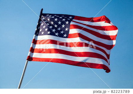 American flag waving on blue sky background 82223789