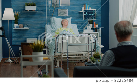 Patient with sickness laying on hospital bed in nursing home 82225484