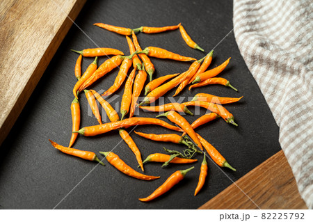 Hot yellow chili or chilli pepper on stone table. 82225792