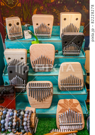 Kalimba or Mbira musical instrument on stand of Exhibition and sale of handmade folk instruments. Relaxation methods and techniques through anti-stress music, healing sounds. Kalimba or Mbira musical instrument on stand of Exhibition and sale of handmade folk instruments. Relaxation methods and techniques through anti-stress music, healing sounds. 82228278