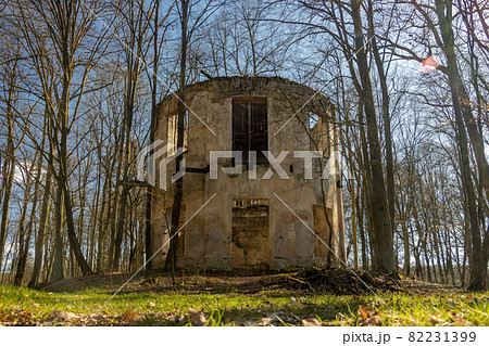 The ruin of a circular building between trees with fallen leaves, Czech republic. 82231399