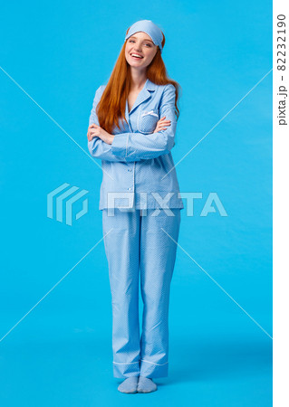 Lifestyle, people concept. Happy good-looking glamour redhead european female in nightwear and sleep mask, cross arms chest and smiling delighted, feeling energized morning Lifestyle, people concept. Happy good-looking glamour redhead european female in nightwear and sleep mask, cross arms chest and smiling delighted, feeling energized morning 82232190