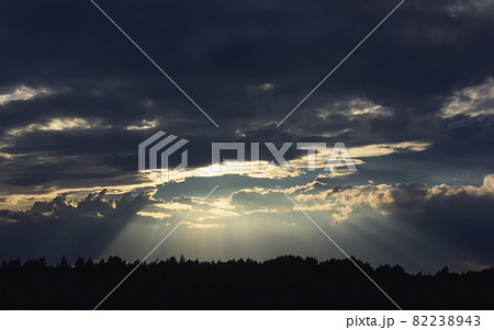 Dark Dramatic Sky with Sunbeams Through Storm Clouds 82238943