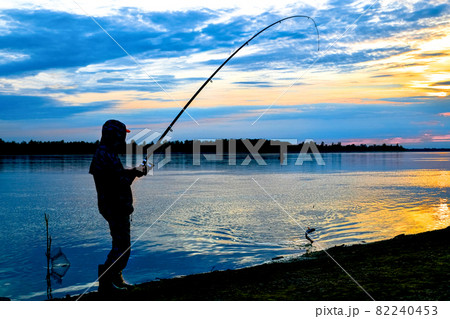 Successful fishing on the river at sunset. 82240453