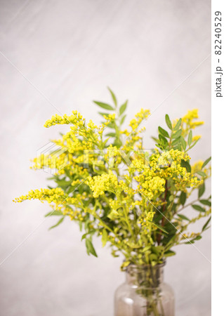 Bouquet of beautiful yellow flowers in vase on gray background. 82240529
