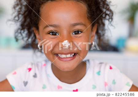 Portrait of happy african american messy with dough girl looking at camera 82245586