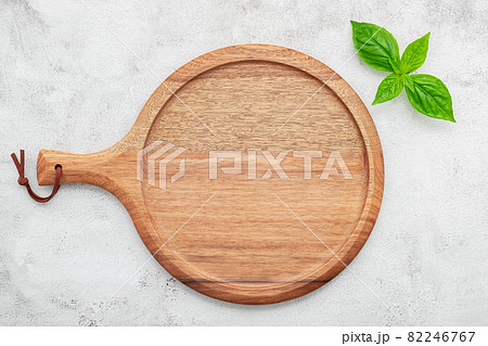 Empty wooden pizza platter set up on white concrete. Pizza tray on white concrete background flat lay and copy space.. 82246767