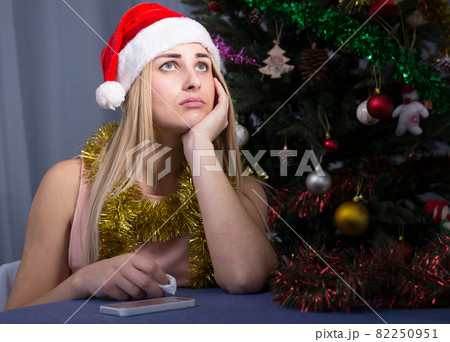 Sad woman is bored lonely in New Year night Sad woman is bored lonely in New Year night 82250951