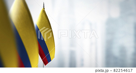 Small flags of Colombia on a blurry background of the city 82254617