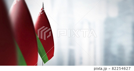 Small flags of Belarus on a blurry background of the city 82254627