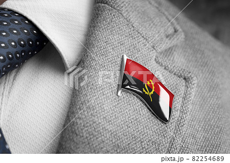Metal badge with the flag of Angola on a suit lapel 82254689