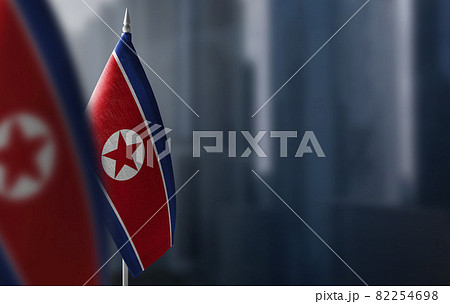 Small flags of North Korea on a blurry background of the city Small flags of North Korea on a blurry background of the city 82254698