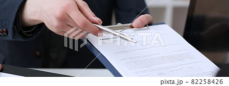 Male hand holding silver pen 82258426