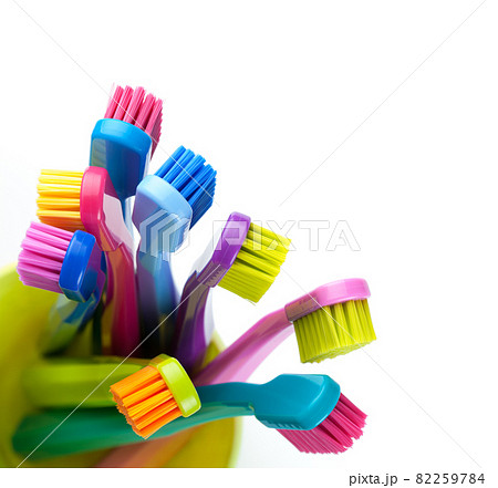 New Toothbrushes In Cup Isolated On White 82259784