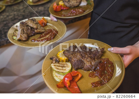 Grilled Steak Striploin and Pepper sauce on cutting board on dark wooden background. Grilled Steak Striploin and Pepper sauce on cutting board on dark wooden background. 82260664