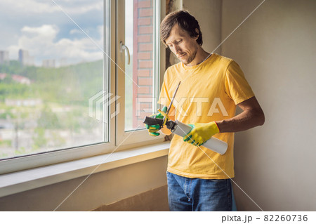 Builder or handyman is engaged in the repair or installation of windows 82260736