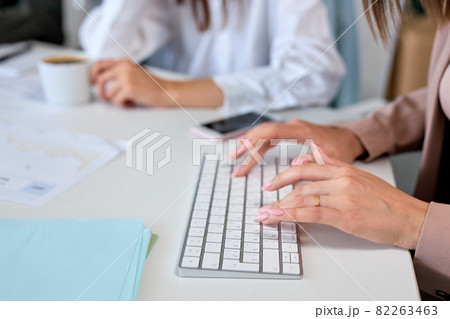 Hands of businesswoman on computer keyboard, typing, working at office. Hands of businesswoman on computer keyboard, typing, working at office. 82263463