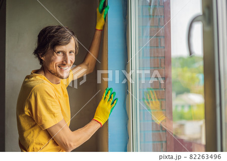 Builder or handyman is engaged in the repair or installation of windows 82263496