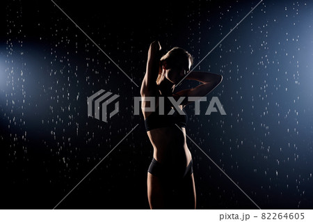Passionate beautiful young woman posing under rain, fitness athlete lady in underwear Passionate beautiful young woman posing under rain, fitness athlete lady in underwear 82264605