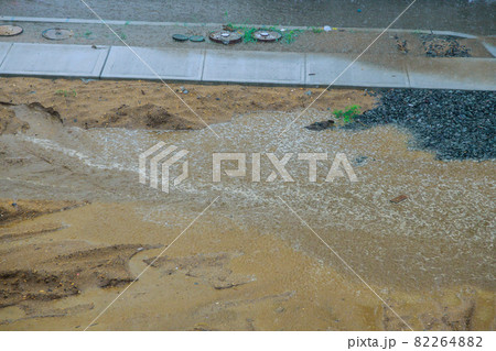 Road filled with water are very difficult to cross the road during thunderstorm 82264882