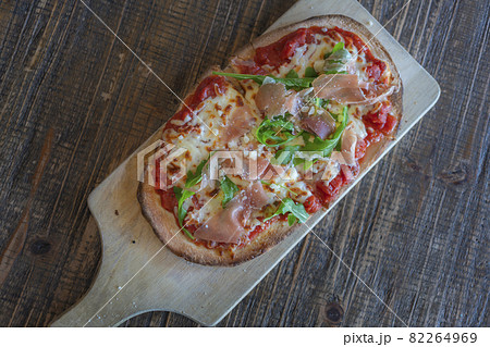 Pizza. Traditional italian pizza with green basil pesto sauce, top view stock photo Pizza. Traditional italian pizza with green basil pesto sauce, top view stock photo 82264969