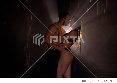 Side View Portrait Of Semiundressed Caucasian Couple Posing, In Love, Light In The Background 82265191