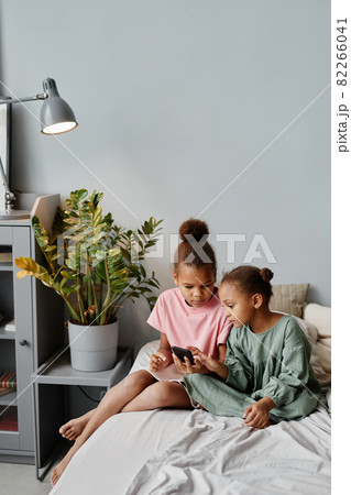 Two African American Girls using Smartphone at Home 82266041
