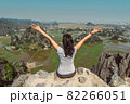 Woman on the edge of the cliff raising her hands 82266051