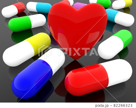 Red heart between medicine capsules on black background 82266323