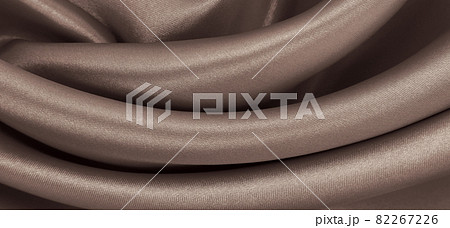 Smooth elegant brown silk or satin texture as abstract background. Luxurious background design. In Sepia toned. Retro style Smooth elegant brown silk or satin texture as abstract background. Luxurious background design. In Sepia toned. Retro style 82267226