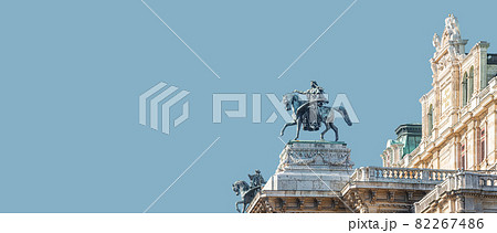 Banner with top roof sculpture of Greek goddess Muse riding Pegasus, a winged horse, at Vienna State Opera House, Vienna, Austria, with copy space. Concept of Cultural Heritage and Travel. 82267486