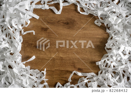 Frame of shredded paper on wooden table for background Frame of shredded paper on wooden table for background 82268432
