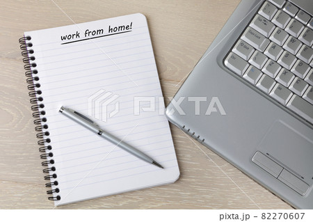 Pad pen and laptop on desk with work from home reminder Pad pen and laptop on desk with work from home reminder 82270607